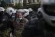 CLAMPING DOWN: Police officers detain a man during a protest