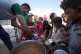 STARVED AND BOMBED: Displaced Palestinian children queue for