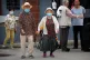 COVID V CHINA: An elderly couple wearing face masks to prote