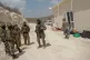 IDF soldiers stand guard as Jewish settlers rebuild the prev