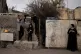 Palestinians in East Jerusalem stand watch at a weekly prote