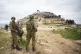 Palestinian demonstrators gather
during a protest against ex