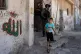 STOLEN LIVES: A local child hurries past invading Israeli po