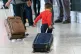 An Afghan refugee pulls a suitcase
