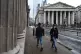 CENTRAL ROLE: People wearing face masks walk past the Bank o