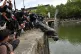 DRAMATIC MOMENT: Protesters throw the statue of merchant and