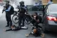 Three women are ordered to the ground by police during a pro
