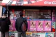 Migrant workers look for work in the window of a newsagent