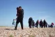 DESPERATE: A group of
refugees cross a beach in
Kent after b