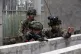 CALLING THE SHOTS: A Philippine army soldier is coached by a
