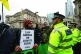 An Extinction Rebellion protester eyes up a cop outside the 