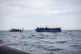 Sea-Eye 4 crew members rescue people from a wooden boat in t