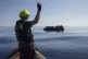 Rescuers from the Humanity 1 approach an overcrowded inflata