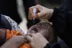 A health worker administers a polio vaccine to a child at a neighbourhood of Karachi, Pakistan, April 21, 2025