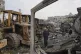 Palestinians examine the remains of bulldozers hit by an Israeli army airstrike in Jabaliya, northern Gaza Strip, April 22, 2025