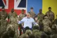 Britain's Prime Minister Keir Starmer (centre) speaks to troops during a visit to a military base training Ukrainian troops with New Zealand's Prime Minister Christopher Luxon, in the west of England, April 22, 2025
