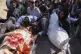 Palestinians mourn over the bodies of their relatives who were killed in an Israeli airstrike, as they brought to Shifa Hospital in Gaza City, April 26, 2025