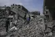 Palestinians walk in the rubbles after an Israeli army air strike in Beit Lahia, northern Gaza Strip, April 28, 2025
