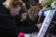 Alyona Zavadska, 16, center, cries over the coffin of her boyfriend Danylo Khudia, 17, killed in a Russian strike along with his parents, Viktoria and Oleh Khudia on April 24, during a farewell ceremony at the crematorium in Kyiv, Ukraine, April 28, 2025