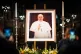 Flowers are placed in front of a picture of Pope Francis at Westminster Cathedral in centra