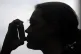 A general view of a female using an inhaler