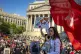 A woman holds a communism flag as people gather for the NYCLU's May Day rally for worker's and immigrant's rights at Foley Square, May 1, 2025, in New York