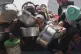 Palestinians struggle to get donated food at a community kitchen in Khan Younis, Gaza Strip, May 5, 2025