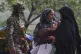 Relatives comfort a Kashmiri women waiting for transportation as they leave following overnight shelling from Pakistan at Gingal village in Uri district, Indian-controlled Kashmir, May 9, 2025