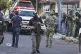 Members of the general prosecutor's office and the Navy stand guard near a vehicle involved in a shootout in Veracruz, Mexico, May 12, 2025