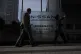Visitors walk past Nissan signage at Nissan headquarters in Yokohama, May 13, 2025