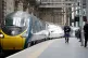 A piper walks the platform alongside the Avanti West Coast Class 390 EMU train as it arrives at Glasgow Central Station from London Euston, failing to break the 36-year-old record for the fastest train journey between London and Glasgow, June 17, 2021