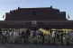 Visitors gather in front of Tiananmen Gate covered with frames and scaffolding for renovations as they wait for the flag lowering ceremony on the eve of the June 4 anniversary, in Beijing, June 3, 2025