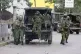 A Kenyan policeman (centre) jumps from a vehicle moments before running and shooting a man who appeared to be a vendor (not pictured) during a protest in Nairobi, June 17, 2025