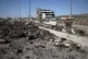 Druze militiamen ride a motorcycle past the site of an alleged Israeli army strike last week on the main road outside Sweida, Syria, July 25, 2025