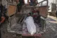 Palestinians mourn around the body of a man killed while trying to reach aid trucks entering northern Gaza through the Zikim crossing with Israel, at Shifa Hospital in Gaza City, July 31, 2025