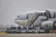 People board a Qatar Airways plane, with federal police vehicles in front of it, on the apron at Leipzig/Halle Airport, July 18, 2025, Saxony, Schkeuditz