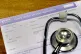 A registration form and a stethoscope at the Temple Fortune Health Centre GP Practice near Golders Green, London
