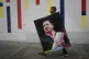 A man carries a poster of late President Hugo Chavez to a rally marking his birthday in Caracas, Venezuela, Monday, July 28, 2025