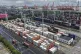 Trucks loaded with container move through a container terminal port in Shanghai, China, Wednesday, July 30, 2025