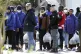 Migrants follow the authorities after their arrival in the port of Shengjin, northwestern Albania, January 28, 2025