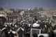 Palestinians carry sacks of flour taken from a humanitarian aid convoy en route to Gaza City, in the outskirts of Beit Lahiya, northern Gaza Strip, August 1, 2025