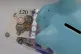 Money in a piggy bank at a home in Ashford, Kent