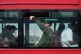 A passenger holds their hand up to an open window as they attempt to cool down, while traveling on a bus crossing Westminster Bridge in central London, August 11, 2025