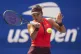Emma Raducanu, of Great Britain, returns a shot to Elena Rybakina, of Kazakhstan, during the third round of the U.S. Open tennis championships, August 29, 2025, in New York
