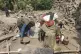 A man collects belongings from the rubble of a collapsed house after a powerful earthquake struck eastern Afghanistan on August 31, killing many people and destroying villages, in Mazar Dara, Kunar province, Afghanistan, September 3, 2025