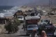 Displaced Palestinians fleeing northern Gaza carry their belongings along the coastal road toward southern Gaza, September 9, 2025, after the Israeli army issued evacuation orders from Gaza City
