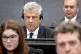 Former Kosovo president Hashim Thaci, left, appears before the Kosovo Tribunal in the Hague, on April 3, 2023