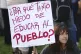 A demonstrator holds a sign that reads in Spanish,