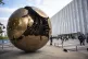 People walk around the plaza by the Sphere Within Sphere outside the United Nations Headquarters on the first day of the 80th session of the UN General Assembly's High-Level week, September 22, 2025