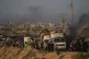 Displaced Palestinians fleeing northern Gaza carry their belongings along the coastal road toward southern Gaza, September 13, 2025